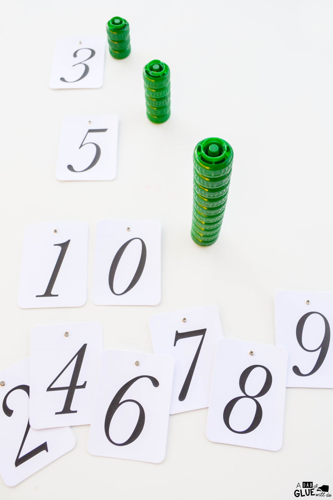 Challenge kids to a stacking challenge with leftover lids. Not only will they have fun trying to win, they can work on counting, numbers, and fine motor skills in the process. Stack a cap math activity is easy to put together, and can be adapted for preschool, kindergarten, or first grade.