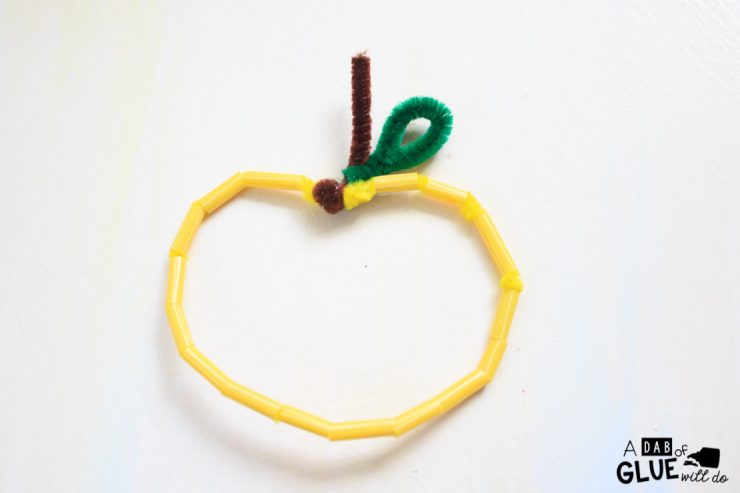 The Pipe Cleaner and Straw Apple craft is simple to make and great for practicing fine motor skills like cutting and lacing, early math & color recognition 