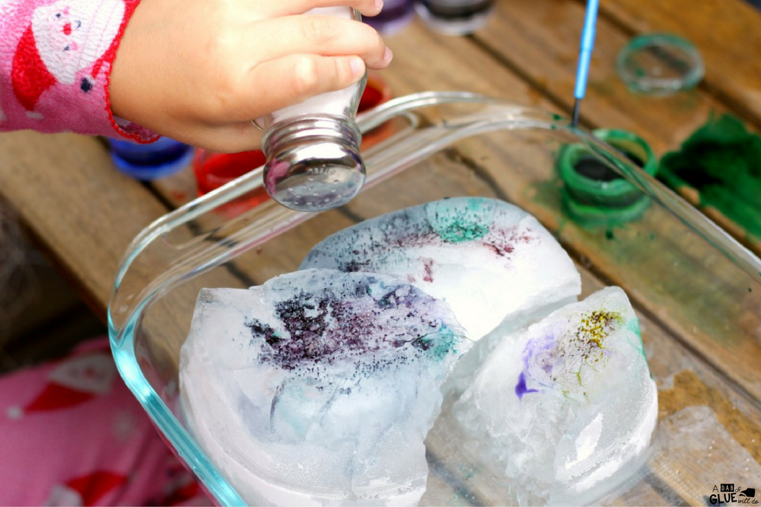 Once in awhile we find a science experiment that is just as much art as it is science. Kids in preschool and kindergarten particularly love these creative and colorful science experiments. Ice painting with salt and watercolors is the perfect balance of art of science and is all kinds of fun!