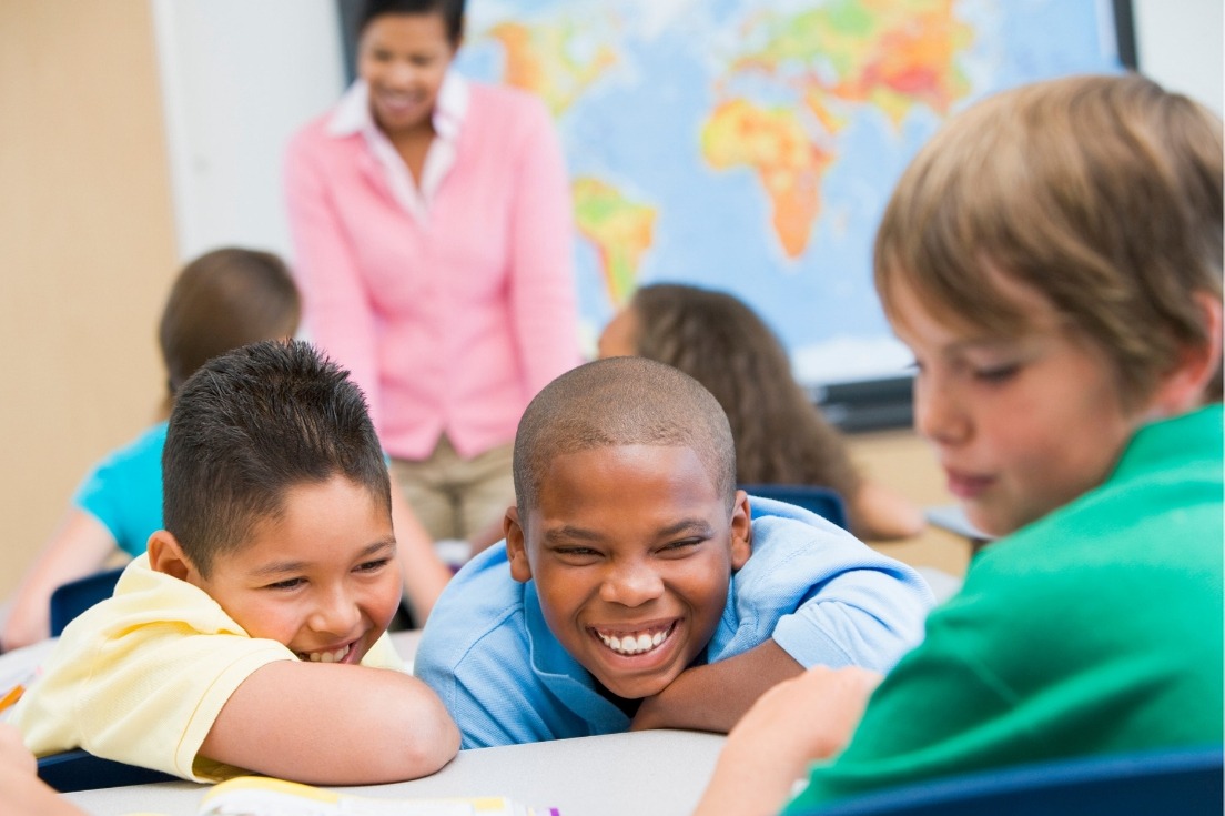 students smiling and talking in the classroom 