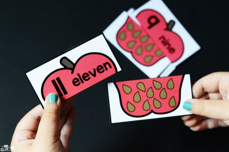 Hands holding number 11 matching apple seed cards. Apple Seed Number Match-Up Activity for Little Learners is a fun way to teach number recognition and number sense.