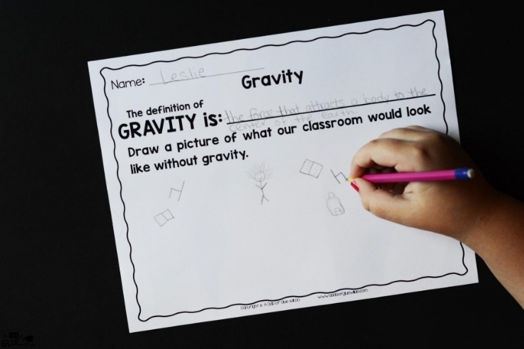 Overhead shot of a kid completing the Gravity worksheet.
