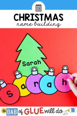Green christmas tree with the name "sarah" on it with multicolored paper ornaments with the letters of the name on them