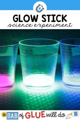 3 cups on a table in the dark with glowing liquid inside