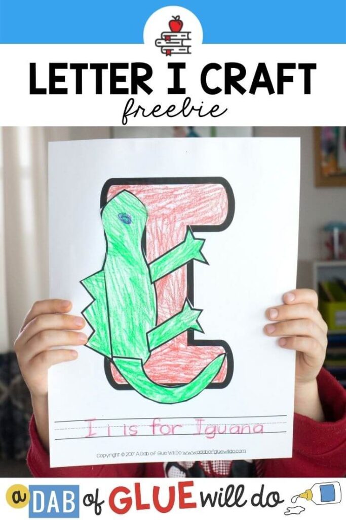 A child holding an I is for Iguana paper craft