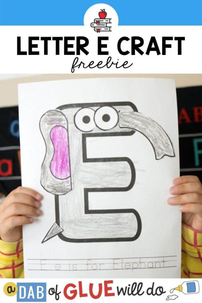 A child holding up an E is for Elephant paper craft