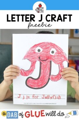 A child holding a J is for Jellyfish Craft