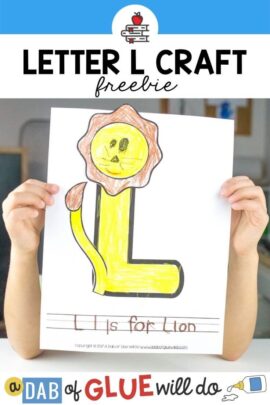 A child holding an L is for Lion paper craft