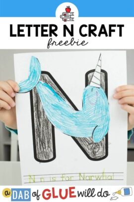 A child holding a N is for Narwhal craft