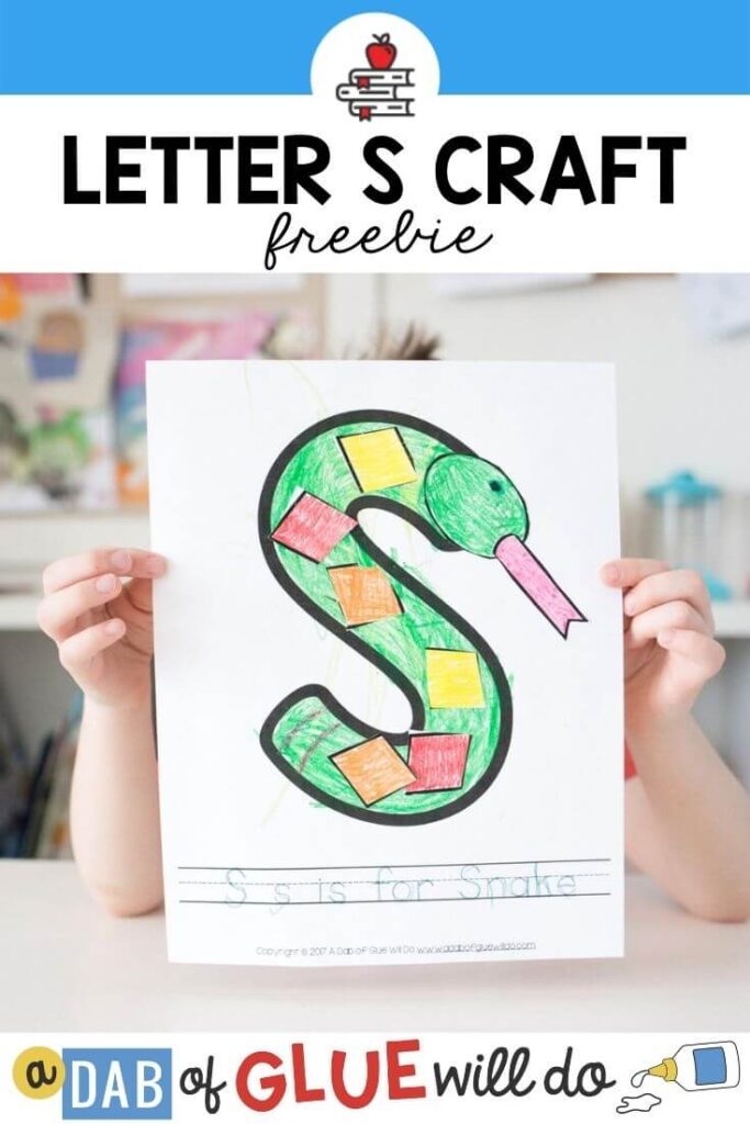 A child holding up a S is for snake craft