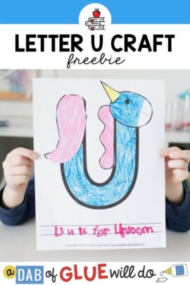 A child holding up a U is for Unicorn Craft