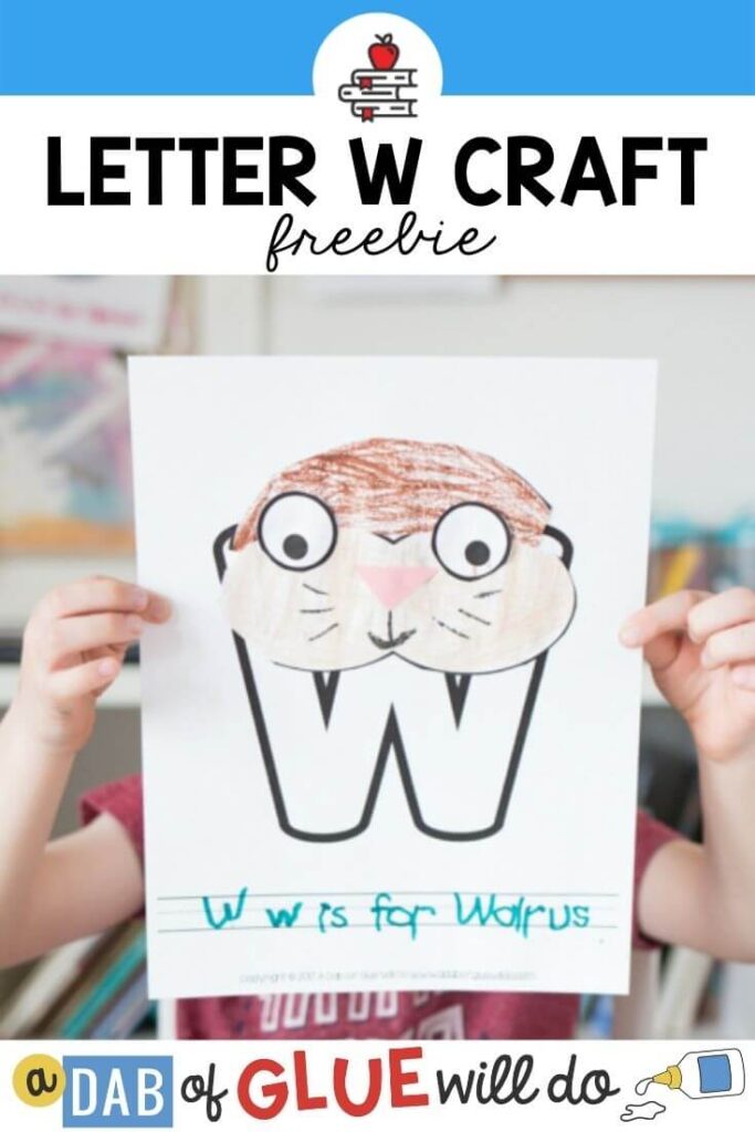 A child holding up a W is for Walrus craft