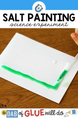 The letter L made out of salt on a paper with green liquid in a dropper being dropped on