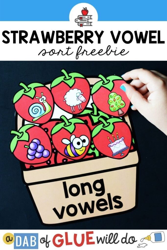 A basket labeled "long vowels" with strawberry picture cards piled on top that have pictures of words with long vowels on it