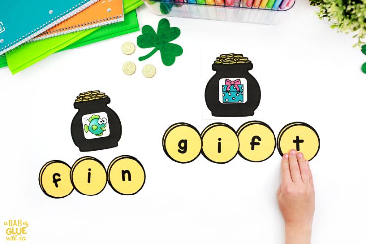 St. Patrick's Day word building with fin and gift on pots of gold